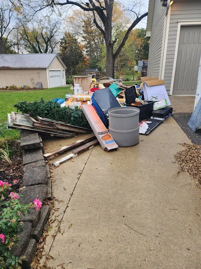 Dumpster being loaded with debris for 10 Yard Dumpster Rental in Stowe